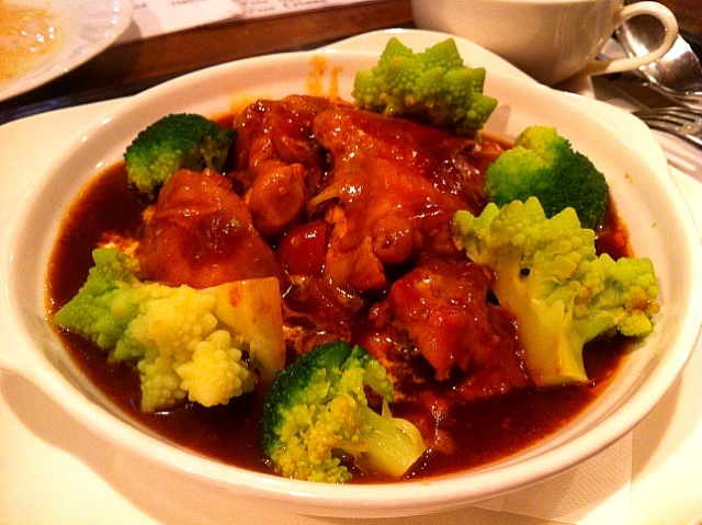 broccoli and meat are served in a bowl