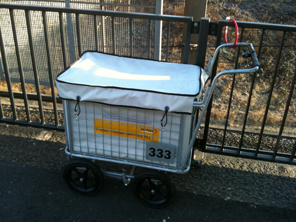 a shopping cart with a white tarp on top of it