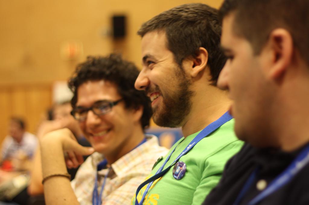 a group of smiling men sitting in a room