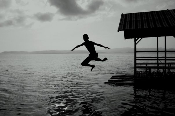 black and white pograph of a man jumping in the air