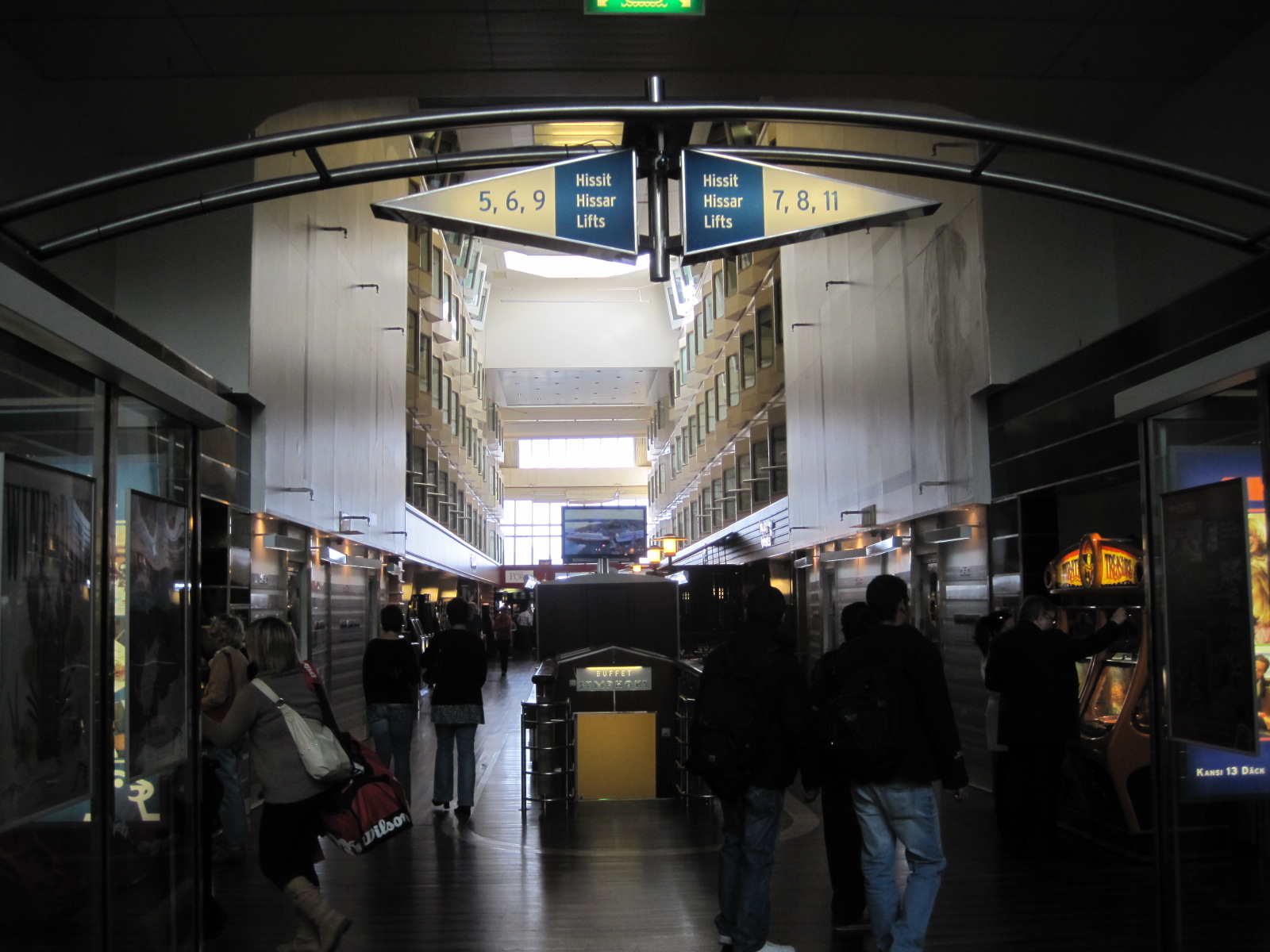 several people walk through an empty shopping mall