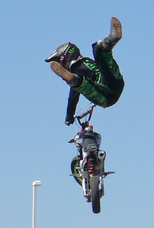 a person on a dirt bike and one man in a helmet flying through the air