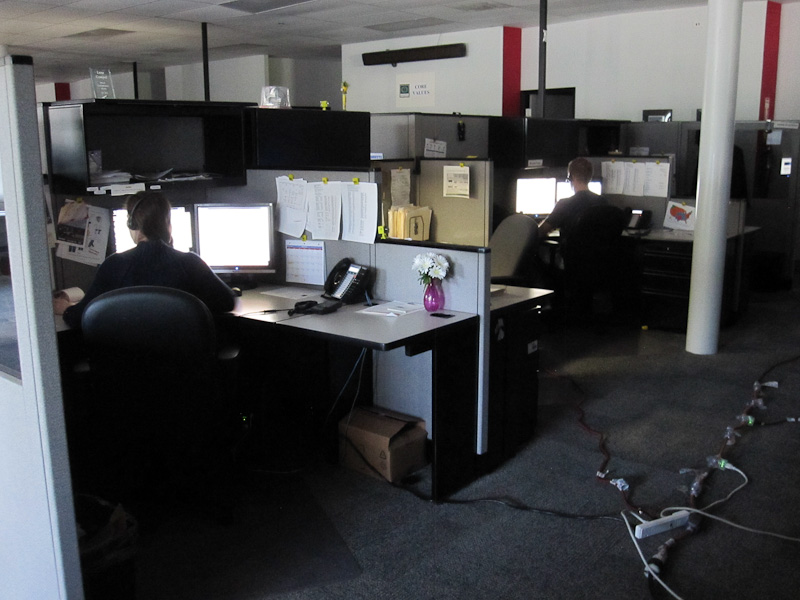a cubicle in the office has all black furniture