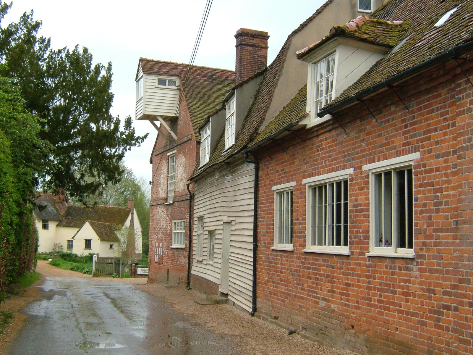 a narrow street that leads to several small homes