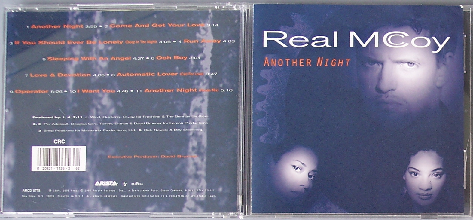 a cd on a white surface and another cd with the title