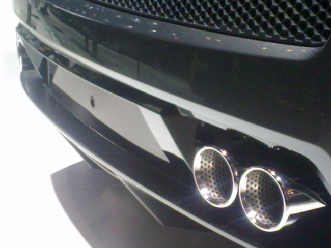 the front of a vehicle, with it's headlights up