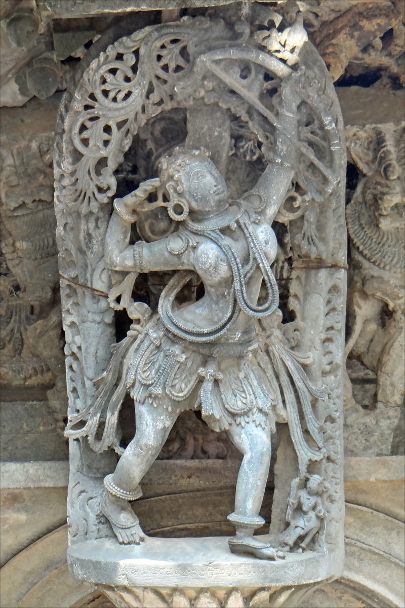 sculpture of a man carrying a large ball