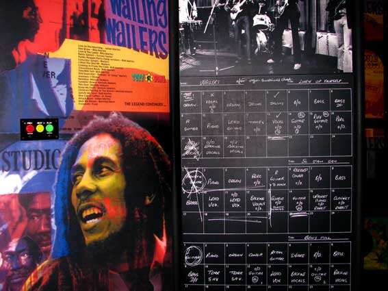 the back of a black and white wall with notes and an image of bob marley