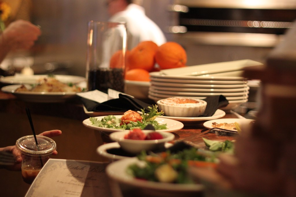 a bunch of people at a table with some food