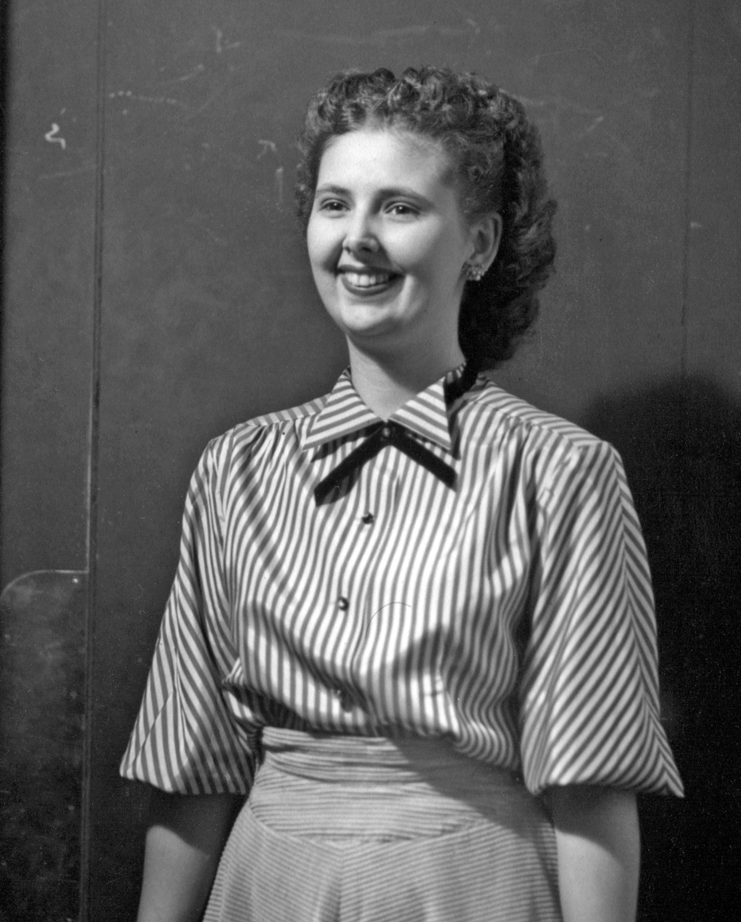 a woman is smiling with a mustache and an apron on