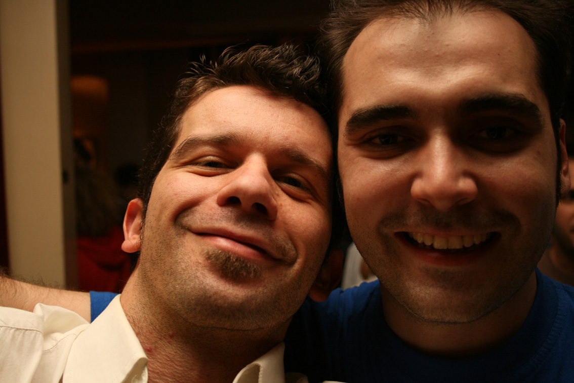 two men posing together for the camera