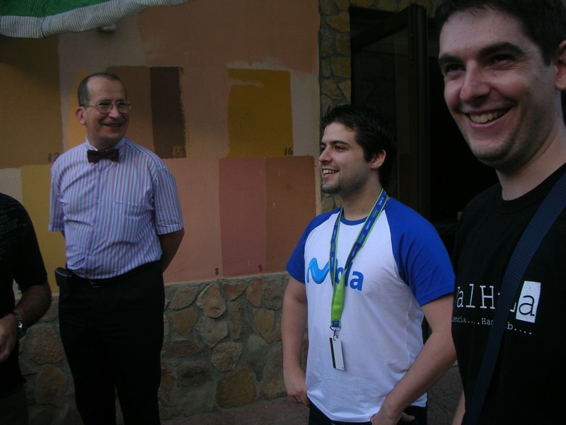 three men are standing outside smiling