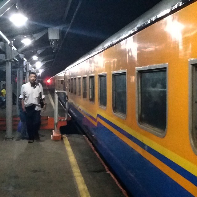 a subway train stopped at the platform with a man