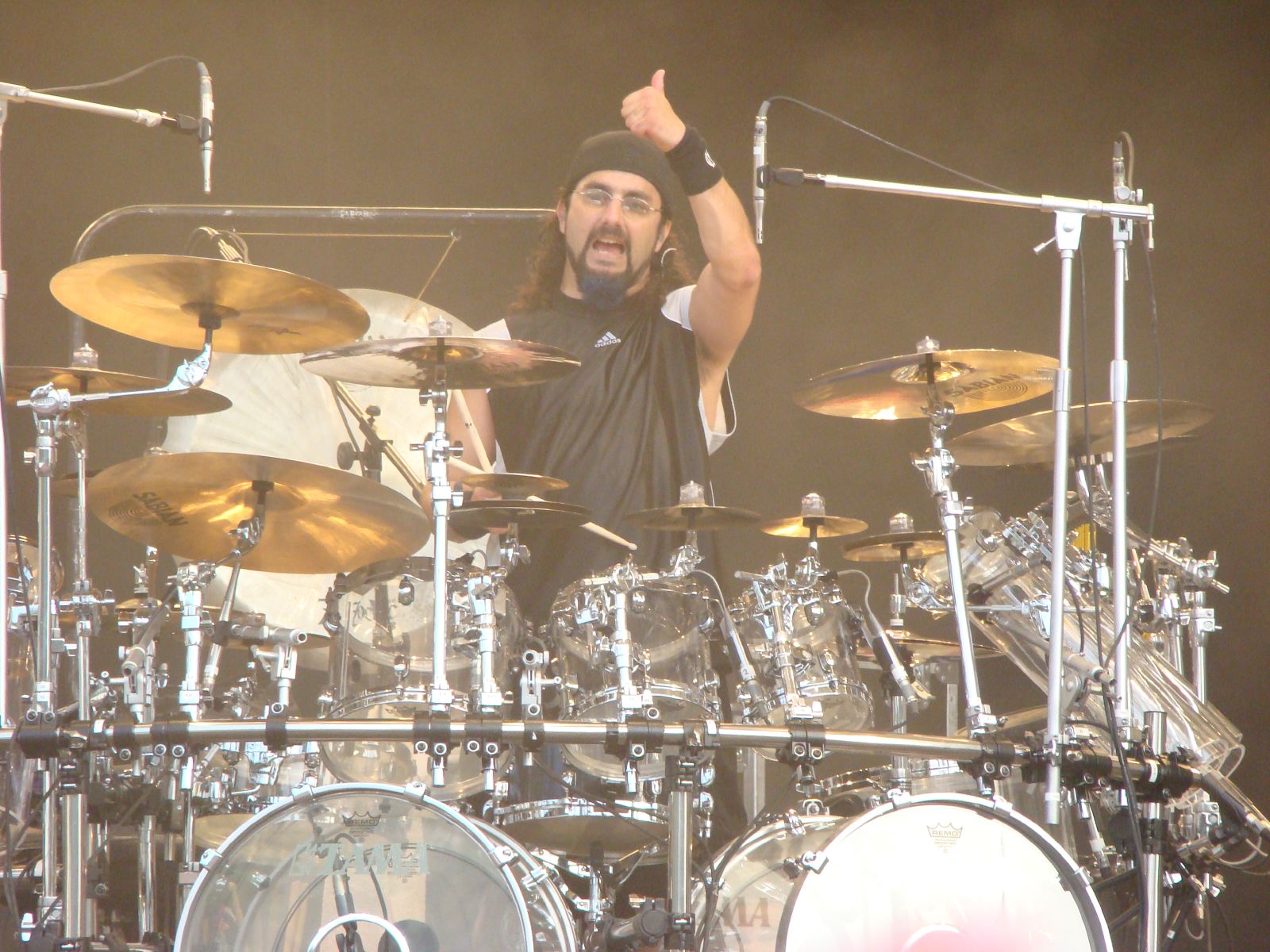 a man playing drums while giving the thumbs up