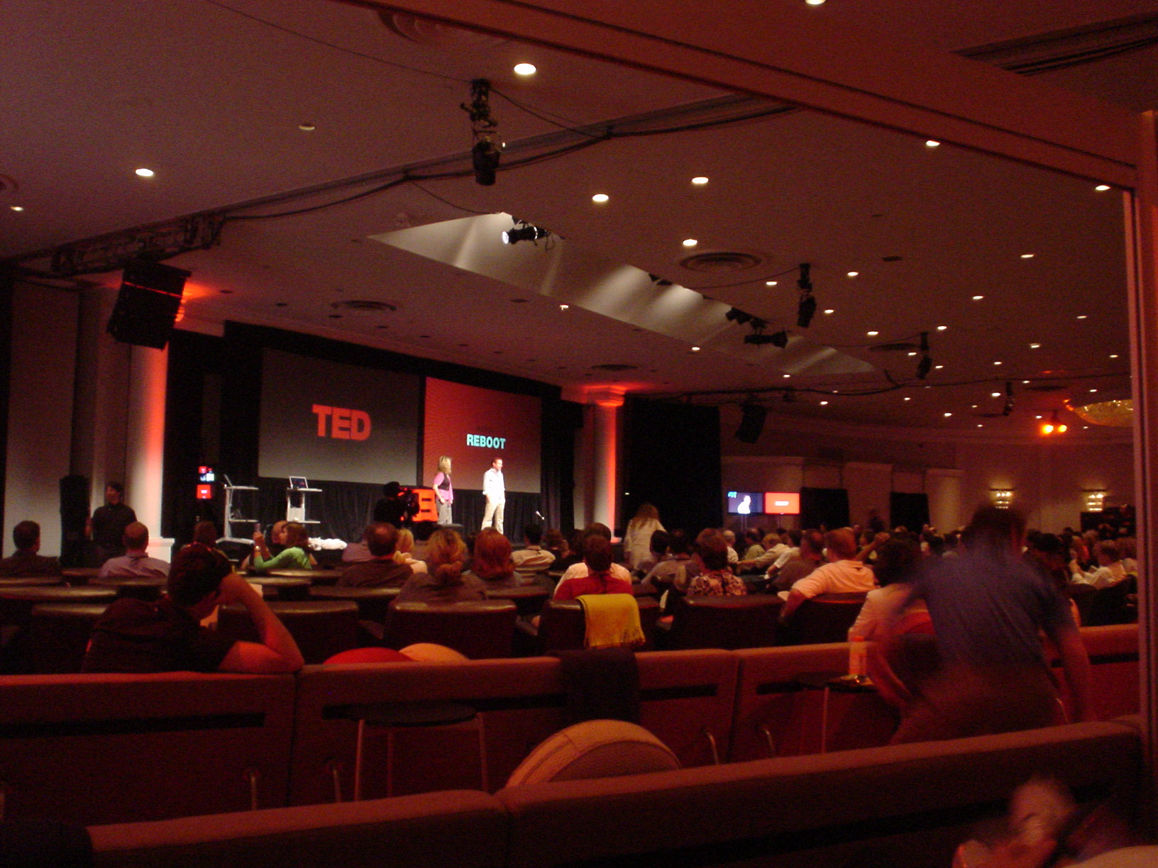 a large audience sits in an auditorium during a lecture