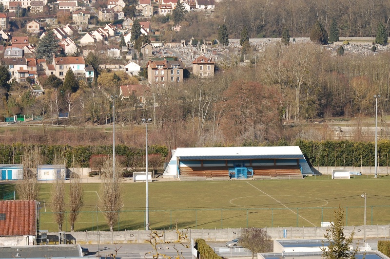 a large soccer field with a building in the background