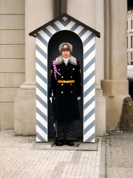 a man in uniform stands at the door of an arch