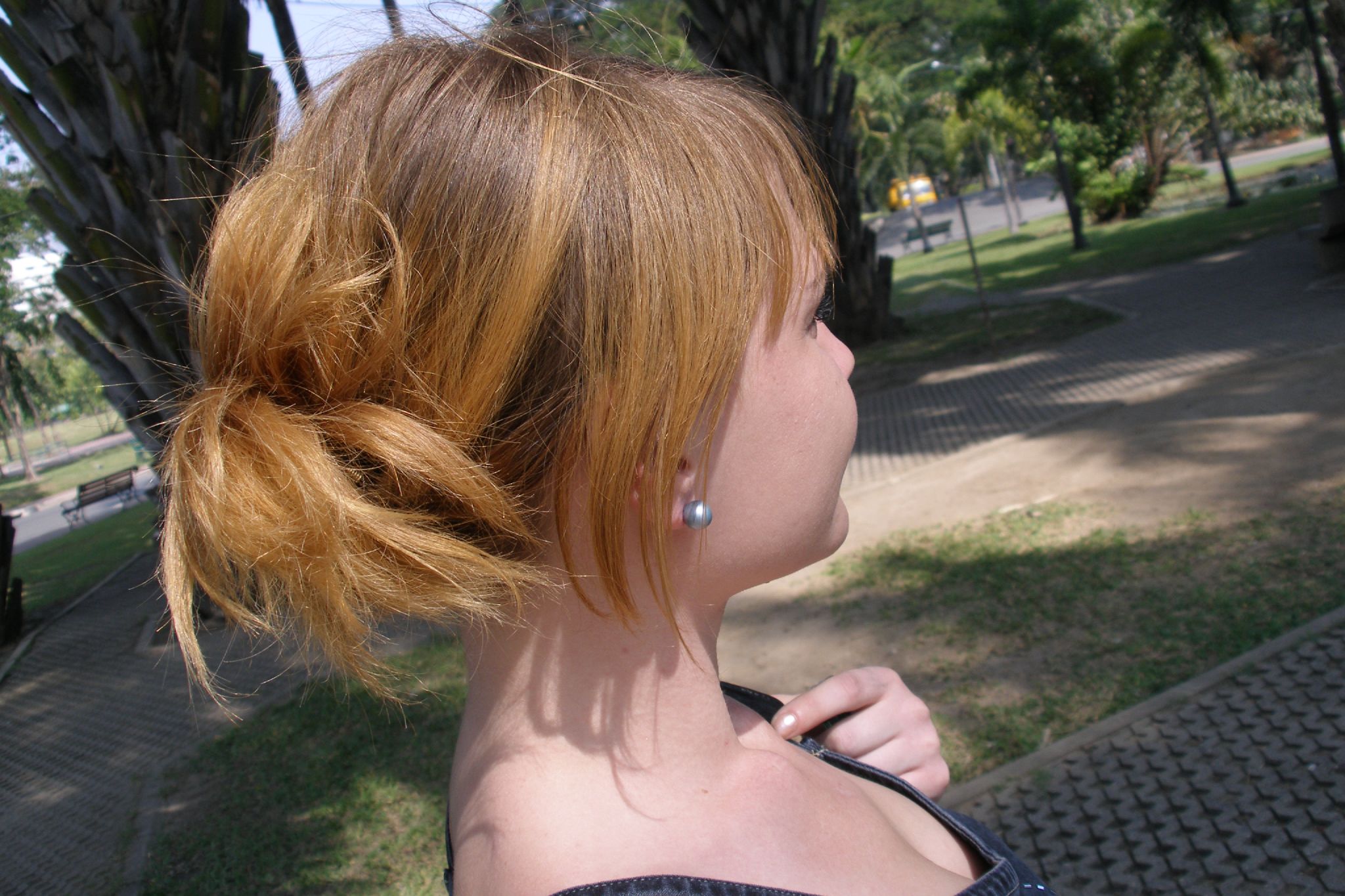red haired girl with earrings and hair blowing in the wind