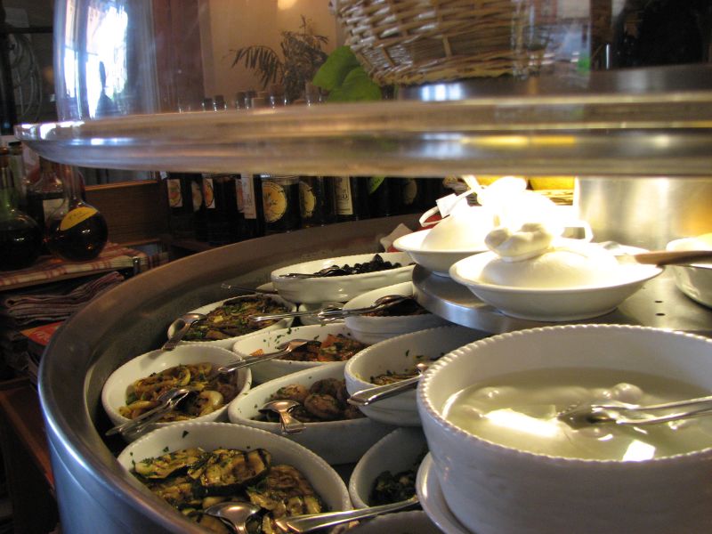 a restaurant serving station with many dishes of soup