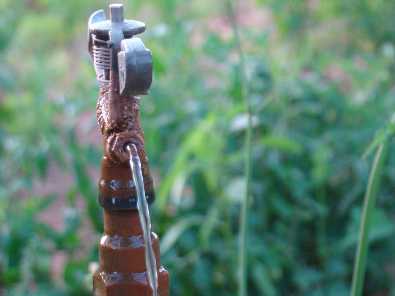 a wrench attached to a rusty metal pole in the field