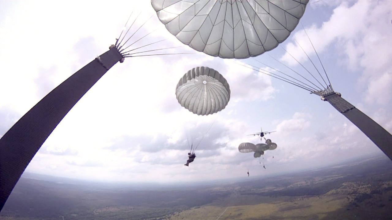 a group of people in air gear with parachutes