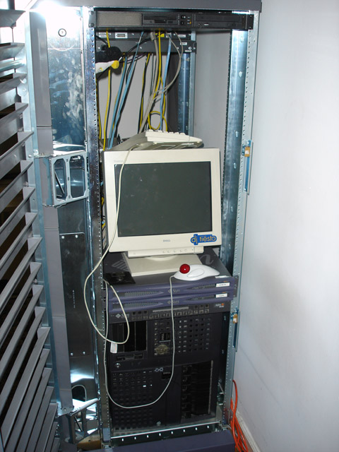 a small old computer sitting on top of an electrical cabinet