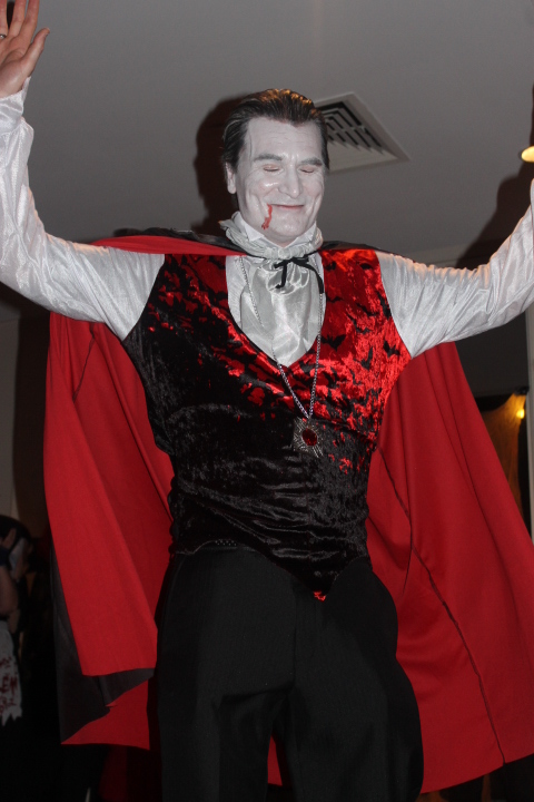 a close up of a person in a costume and a red cape