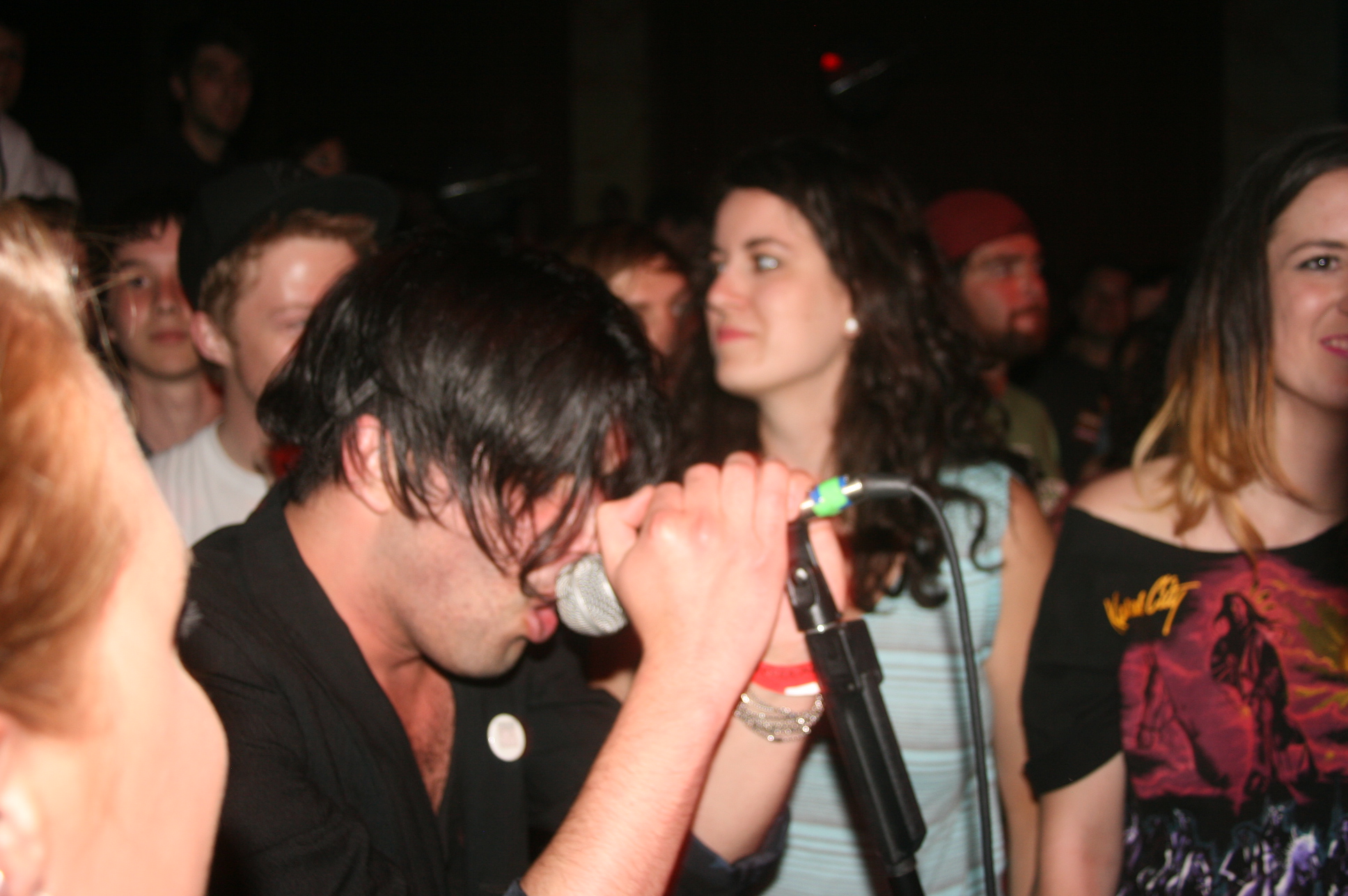 a man standing next to another person holding a microphone in his hands