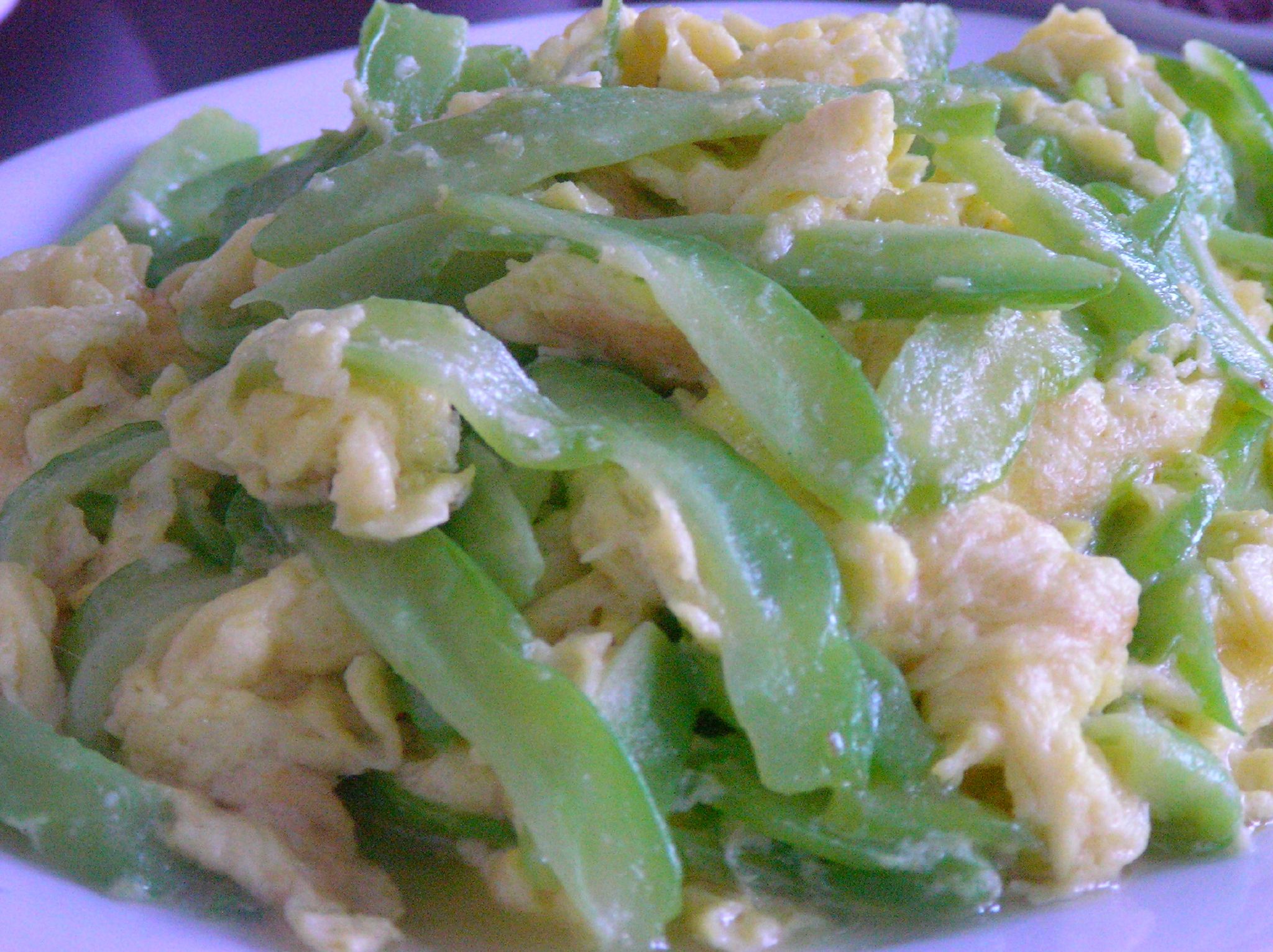 plate of food consisting of green beans and scrambled eggs