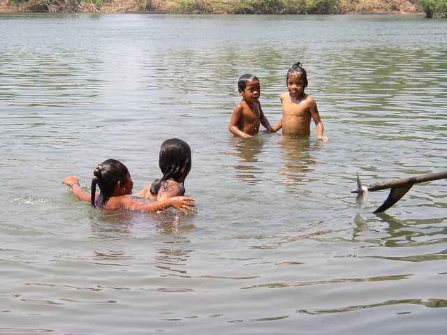 group of girls playing in water with bird nearby