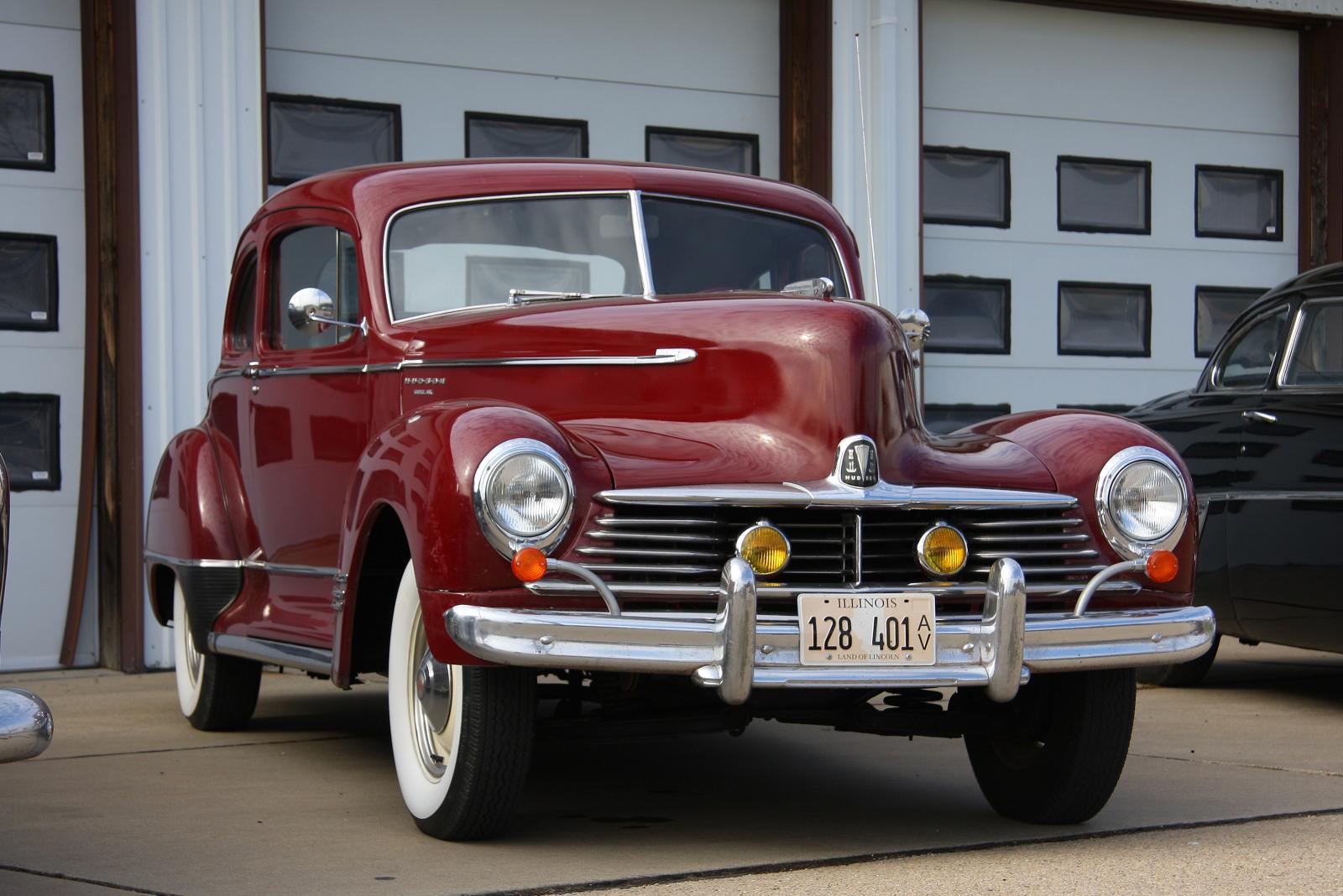 an old classic car parked near another old one