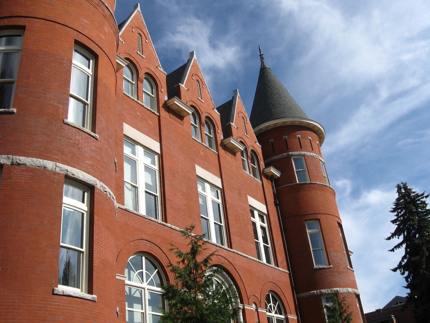 a close up of a large red brick building with a clock tower