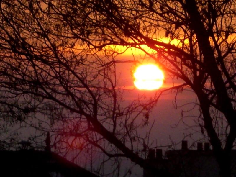 the sun is rising in the distance as it reflects on the water