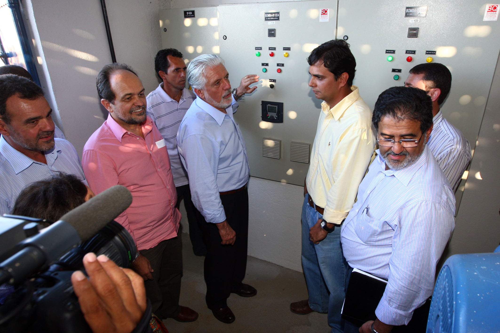 a group of people surrounding a machine talking