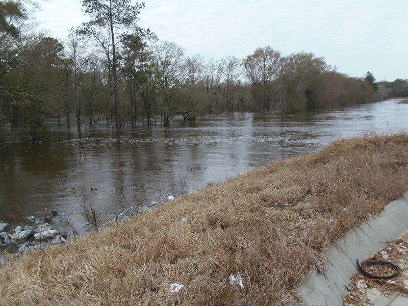 some water is running across the road by the shore