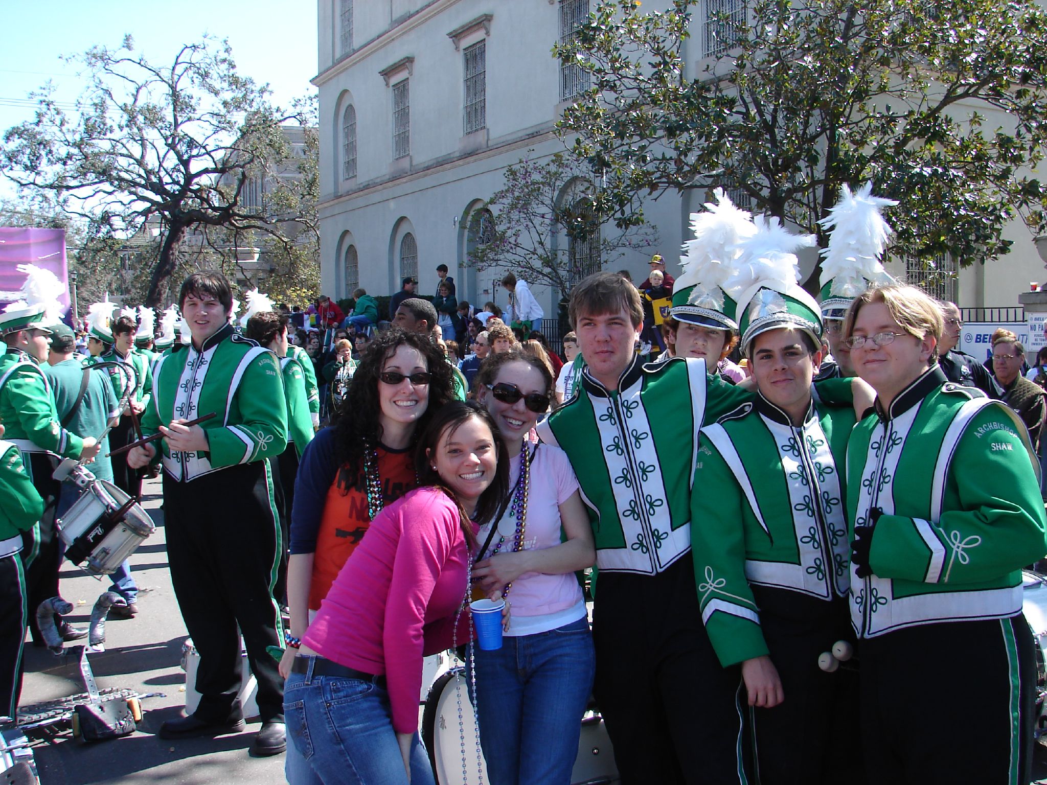 people gathered together with green and white outfits
