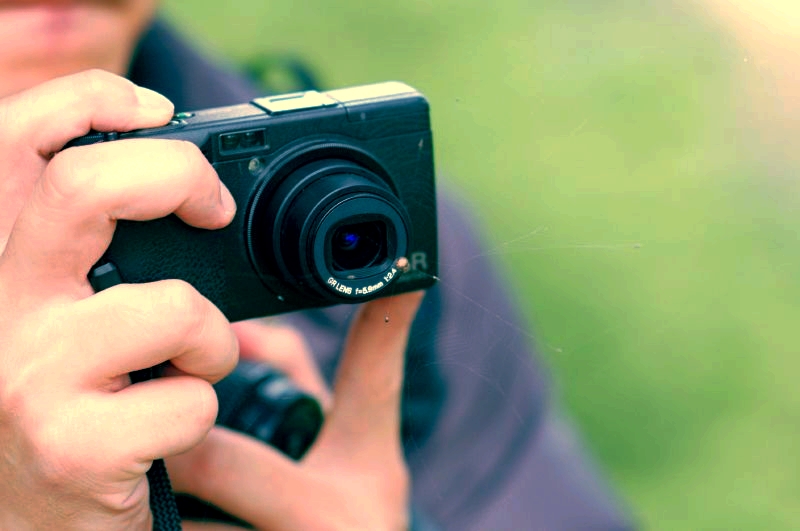 a man that is holding a camera in his hand