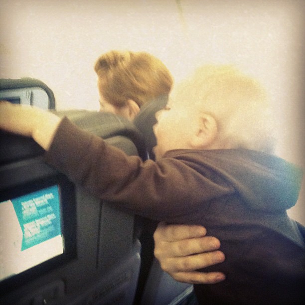 a young child hugging an older person with a hand on the arm