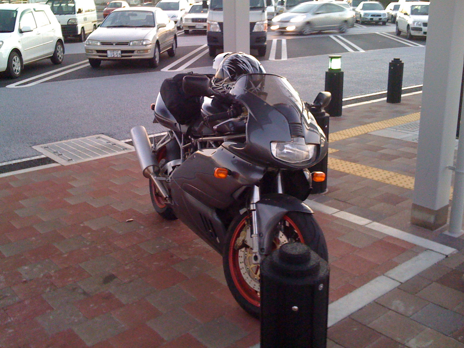 a black motorcycle parked at a gas station