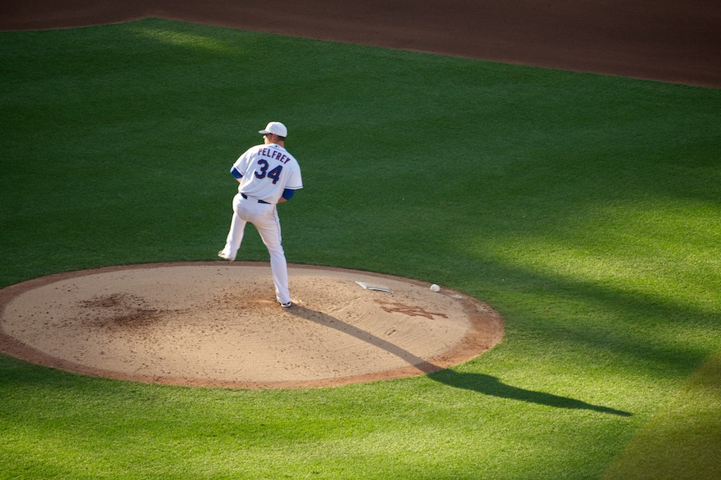 a baseball player standing on the pitcher's mound