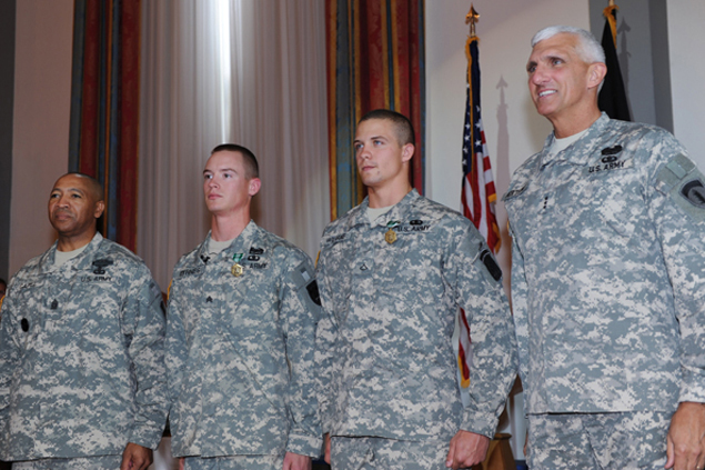 four military officers who are standing together in a room