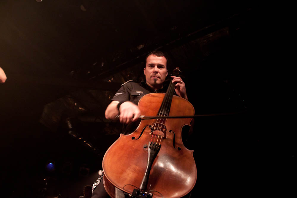 a man that is holding a cellphone and cello