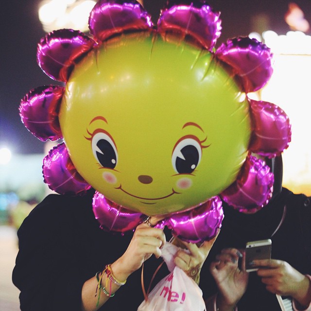 a person with a yellow balloon on their head