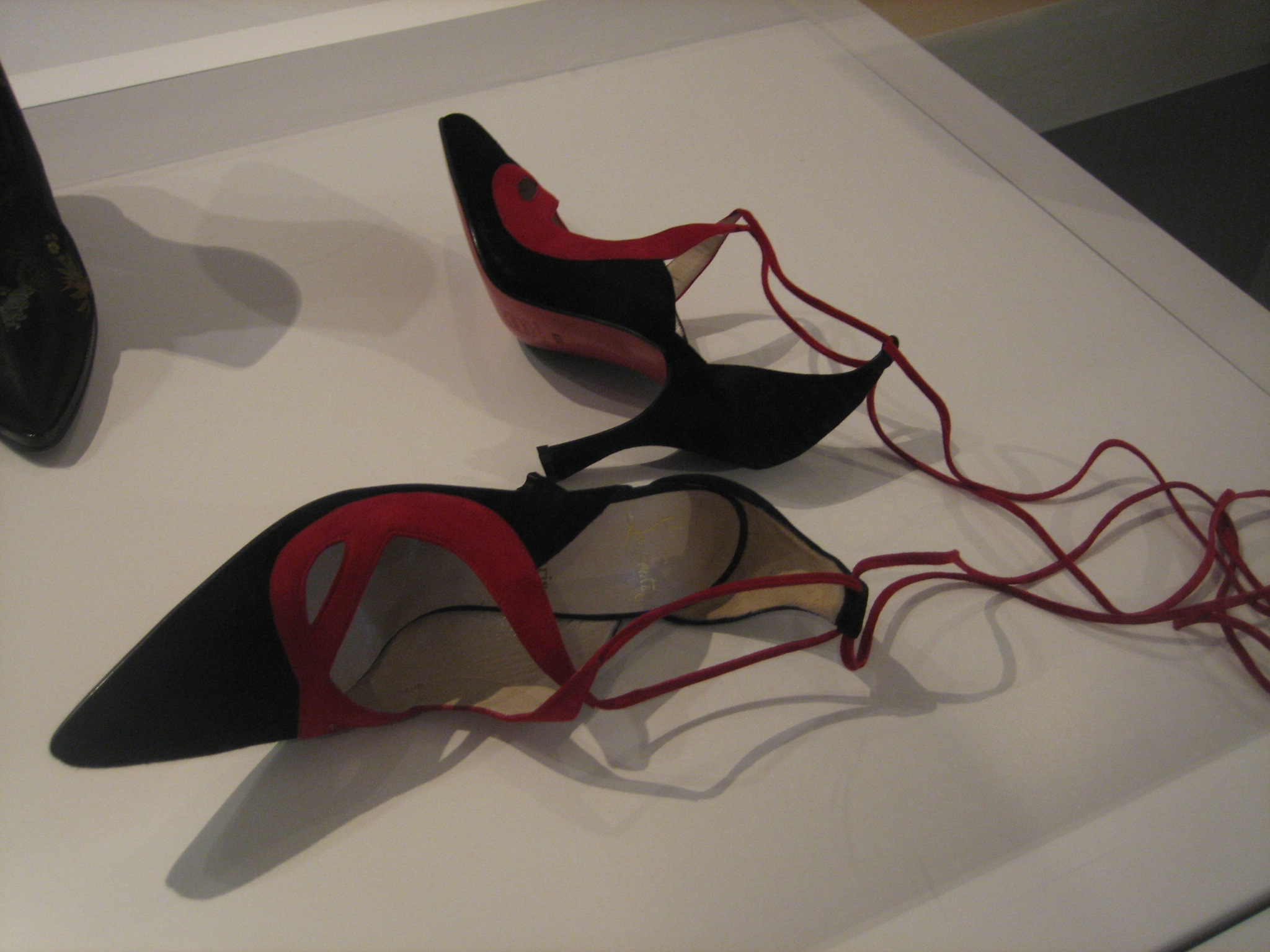 some black and red shoes with ribbons tied to them