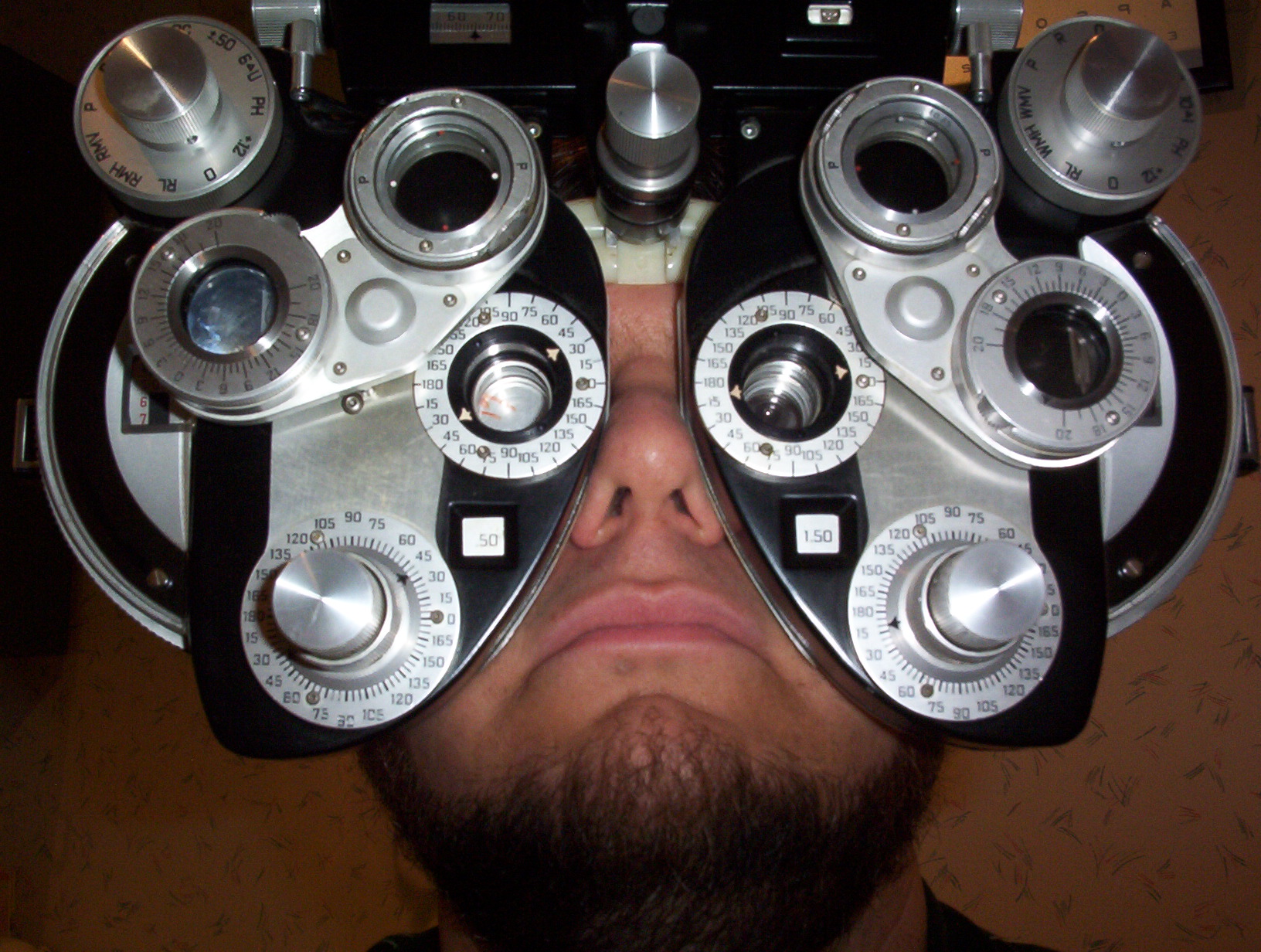 man taking an eyesight test with different type of apparatus
