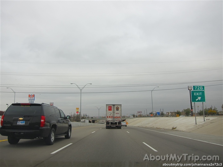 a large truck going down the road with another large truck driving on it