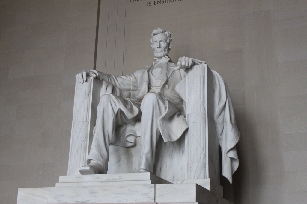 a large statue of a man sitting in a chair