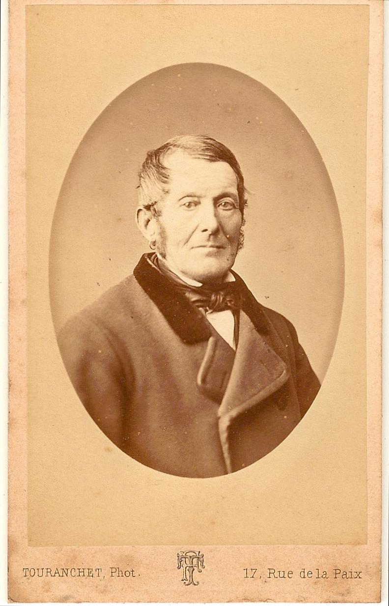 a sepia po of a man in coat with a bow tie