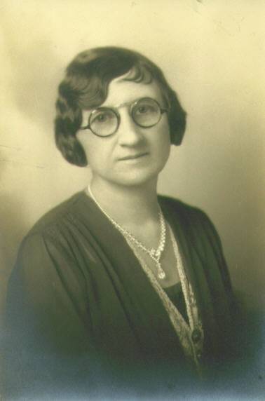 a vintage pograph of a lady wearing glasses