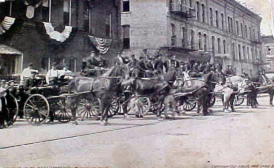 an old po of people standing next to a horse drawn carriage